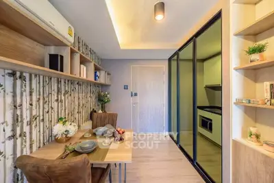 Modern dining area with stylish decor and adjacent compact kitchen in a cozy apartment.