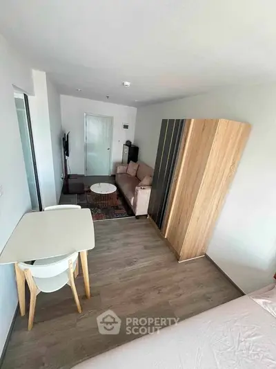 Modern living room with stylish furniture and wooden flooring in a cozy apartment.
