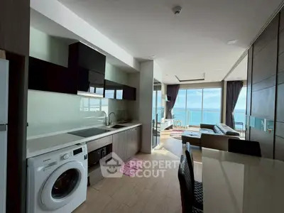 Modern open-layout kitchen and living room with ocean view in luxury apartment