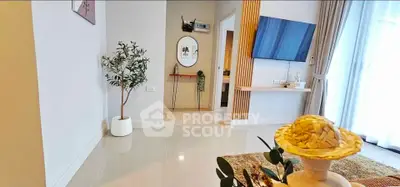 Modern living room with stylish decor and wall-mounted TV, featuring elegant flooring and natural light.