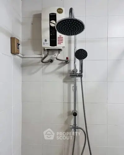 Modern bathroom shower with water heater and dual showerheads.