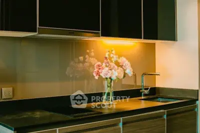 Modern kitchen with sleek cabinets and elegant flower vase