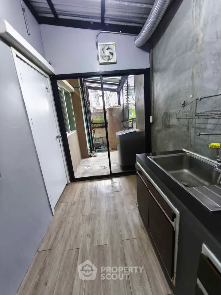 Modern industrial kitchen with sleek metal sink and open layout