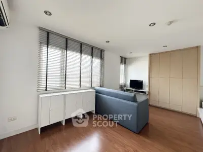 Modern living room with sleek furniture and large windows for natural light