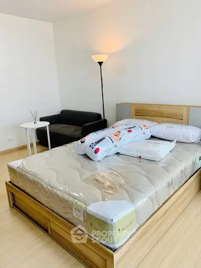 Spacious bedroom with modern decor and cozy lighting, featuring a comfortable bed and stylish furniture.