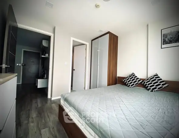 Modern bedroom with stylish decor and wooden flooring