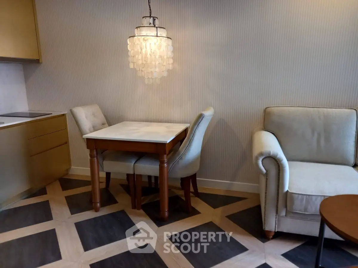 Elegant living room with modern chandelier and cozy seating area