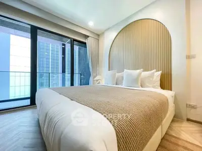 Luxurious modern bedroom with large windows and elegant decor in a high-rise apartment.