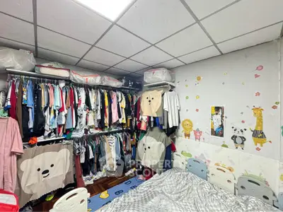 Cozy bedroom with ample closet space and playful wall decor