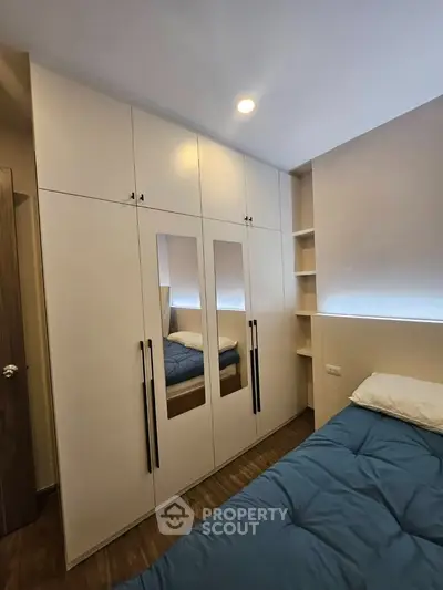 Modern bedroom with built-in wardrobe and cozy bedding