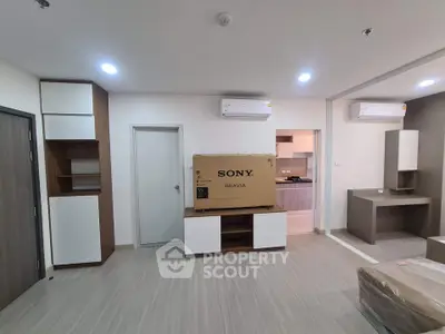 Modern living room with new Sony TV, air conditioning, and sleek furniture in a stylish apartment.