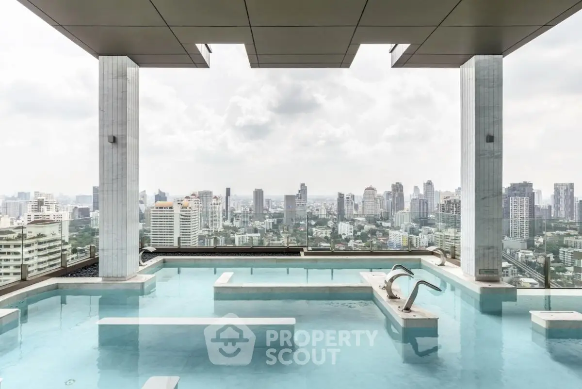 Luxurious rooftop pool with stunning city skyline view, perfect for urban living enthusiasts.