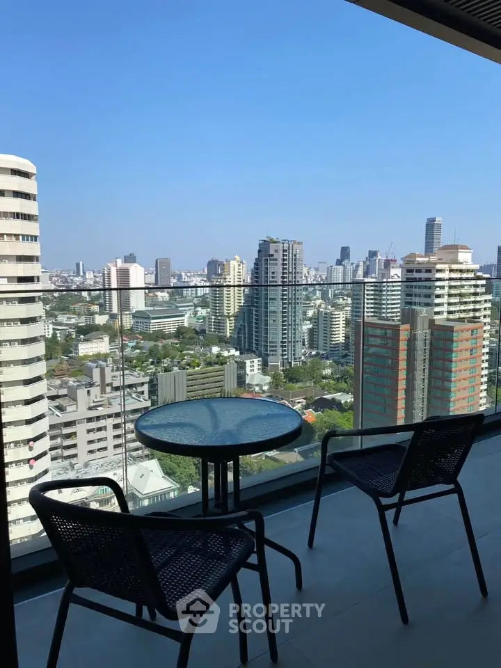 Stunning city view from a modern balcony with seating area