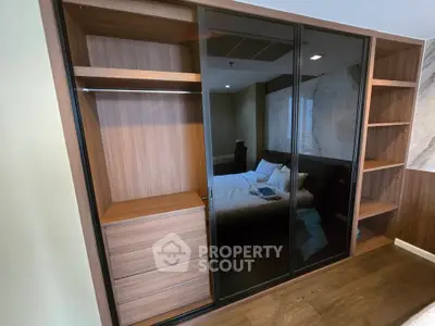 Modern bedroom with sleek wooden wardrobe and cozy bed setup