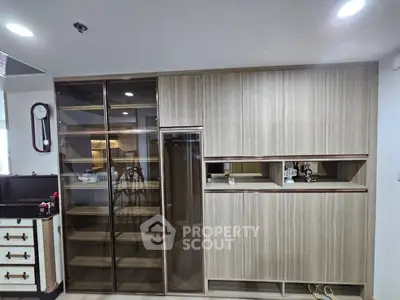 Modern kitchen with sleek cabinetry and glass shelving