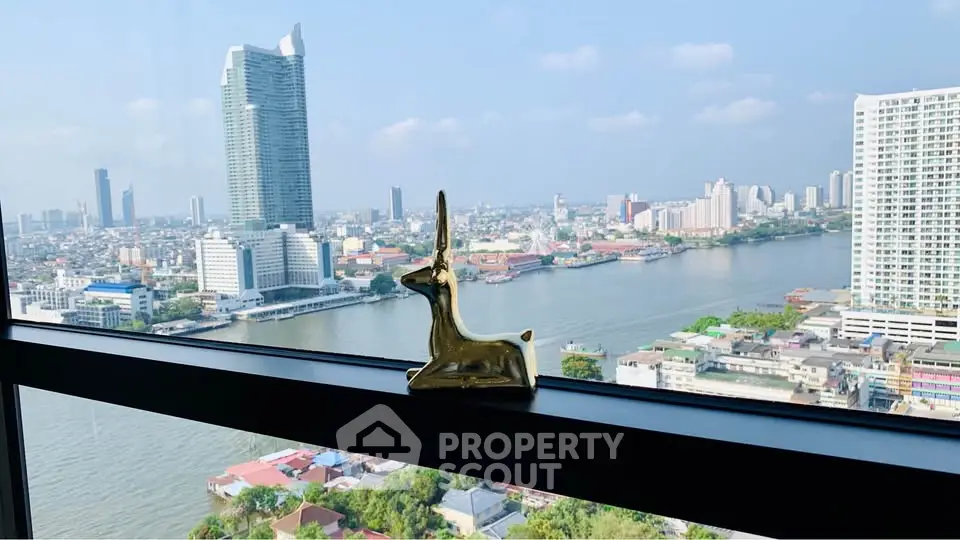 Stunning high-rise river view from modern apartment window with city skyline