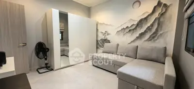 Modern living room with stylish sofa and artistic wall mural