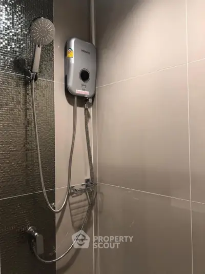 Modern bathroom with sleek shower and water heater installation.