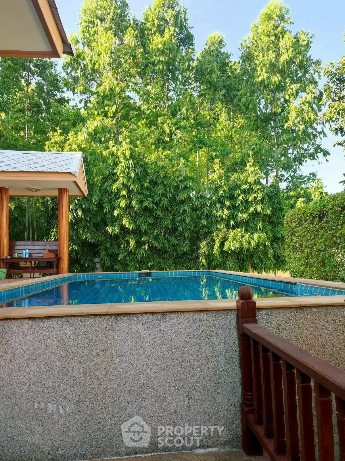 Stunning private pool surrounded by lush greenery, perfect for relaxation and leisure.