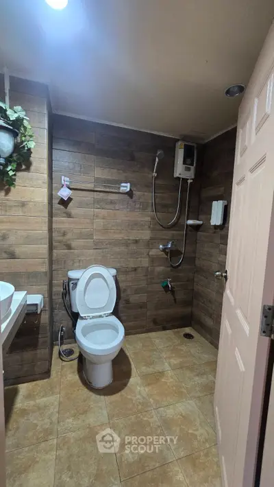 Modern bathroom with wooden tiles and sleek fixtures in a contemporary home.