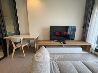Modern living room with stylish furniture and large TV, perfect for entertainment and relaxation.
