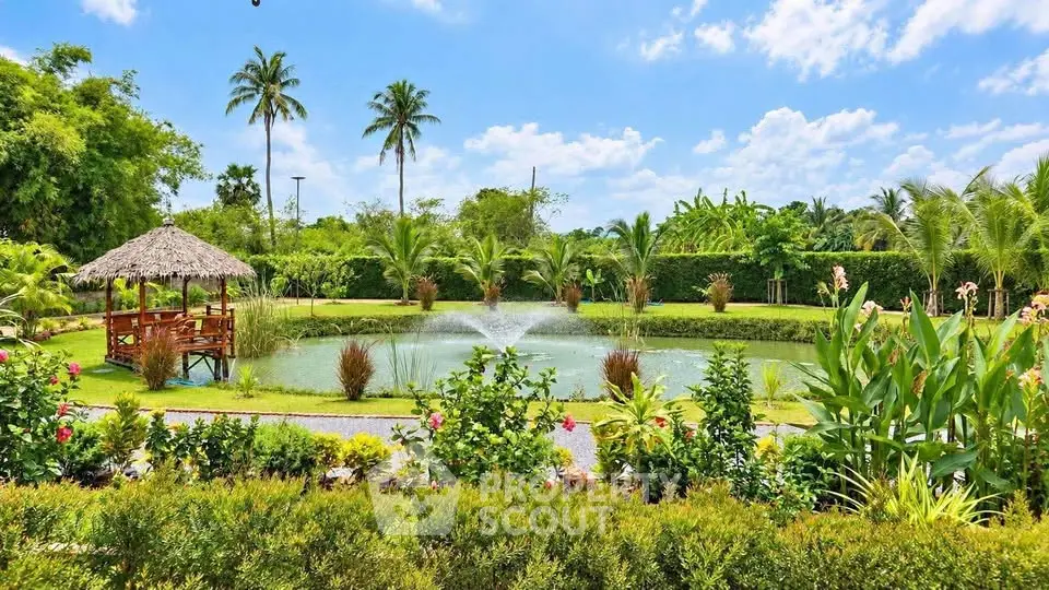 Stunning tropical garden with pond and gazebo, perfect for serene outdoor living.