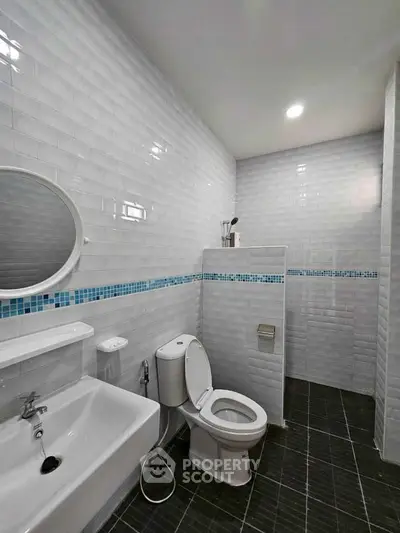 Modern bathroom with sleek white tiles and contemporary fixtures