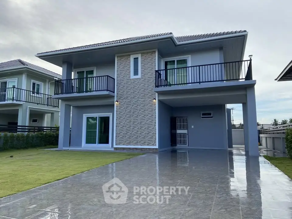 Modern two-story house with sleek design and spacious driveway in a serene neighborhood.