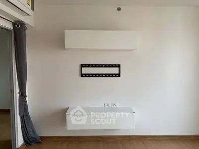 Modern minimalist interior with wall-mounted TV bracket and sleek storage unit