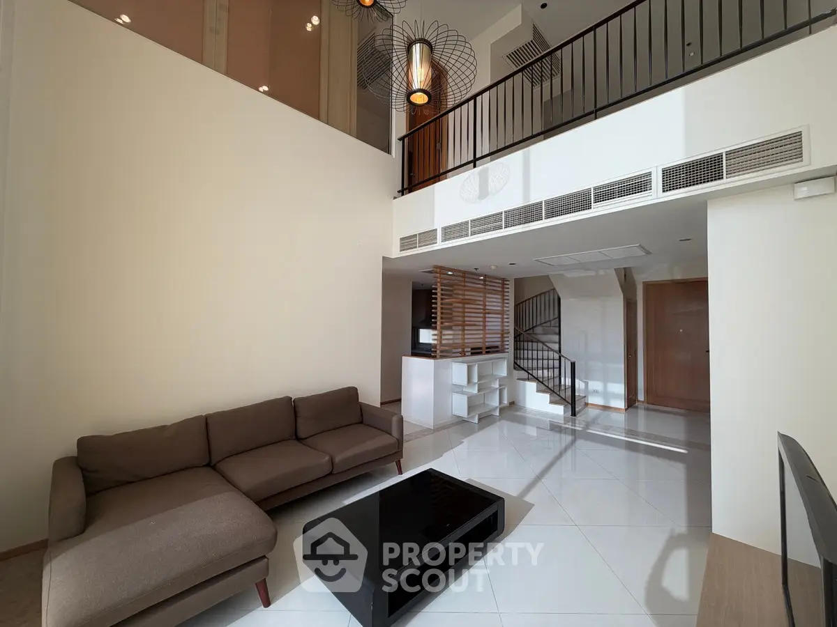 Spacious modern living room with high ceiling and elegant decor