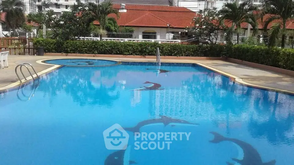 Luxurious swimming pool with dolphin design in a serene residential area