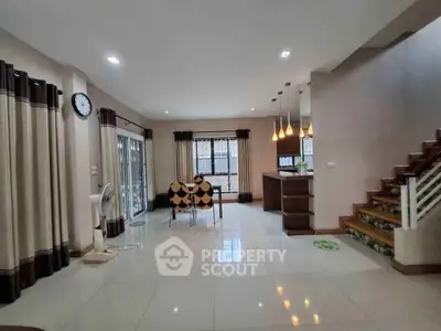 Spacious modern living room with elegant staircase and stylish lighting