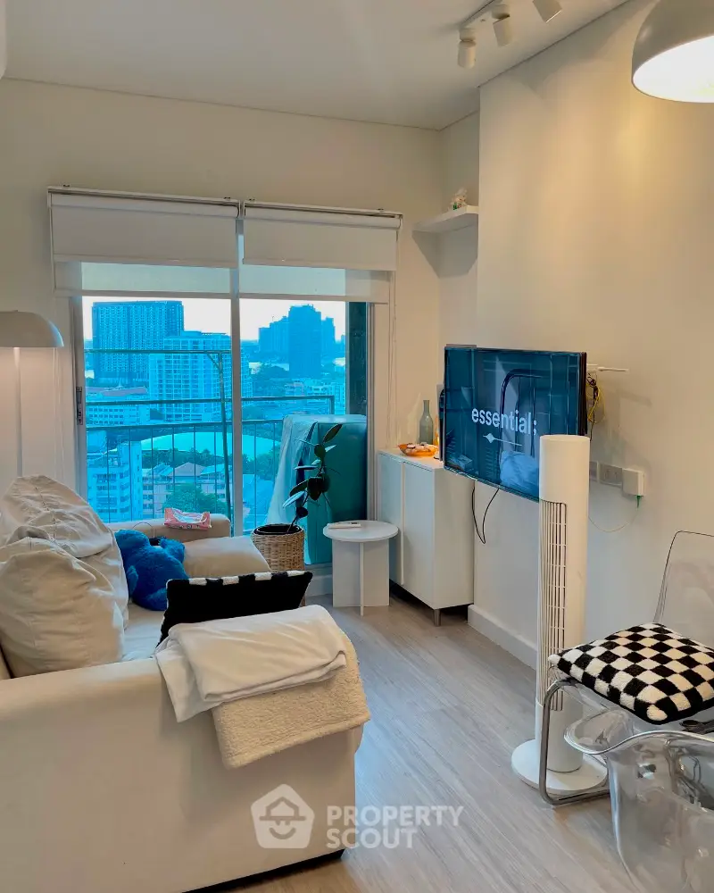 Modern living room with city view, stylish decor, and wall-mounted TV