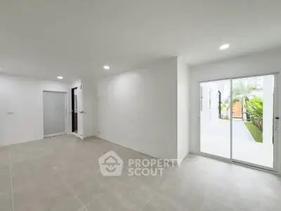 Spacious modern living room with sliding glass doors to garden view