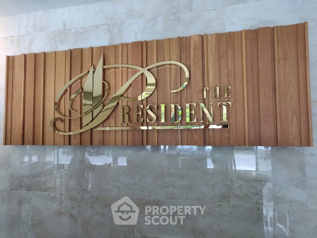 Luxurious building entrance with elegant wooden and gold signage