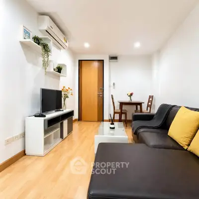 Modern living room with sleek furniture and wooden flooring, perfect for cozy gatherings.