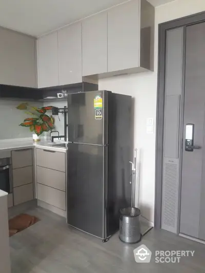 Modern kitchen with sleek fridge and stylish cabinetry