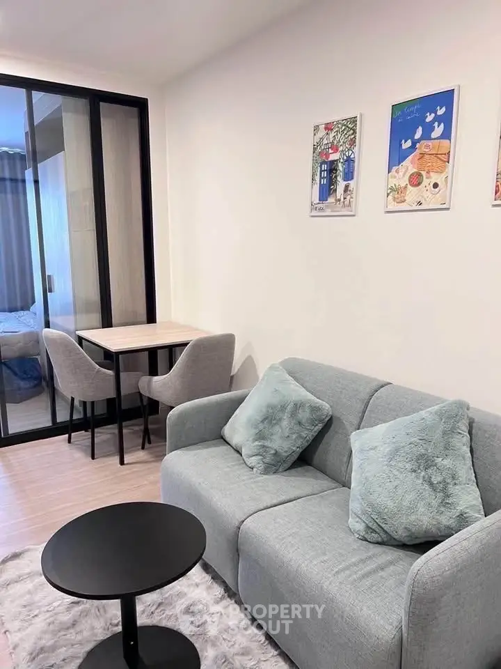 Modern living room with cozy sofa and stylish decor in a contemporary apartment.