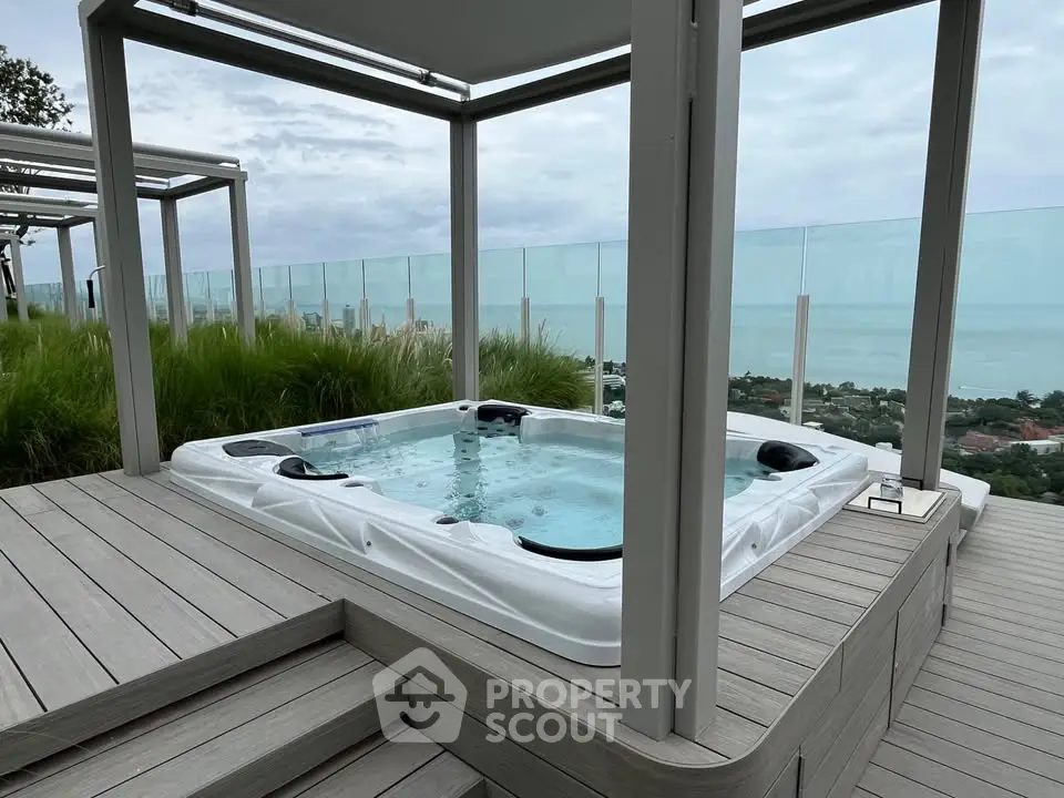 Luxurious rooftop jacuzzi with stunning ocean view and modern design.