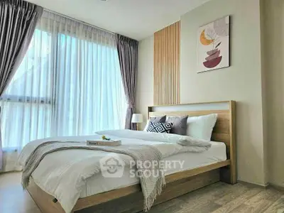 Modern bedroom with stylish decor and large window for natural light