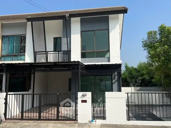 Modern townhouse exterior with sleek design and spacious driveway