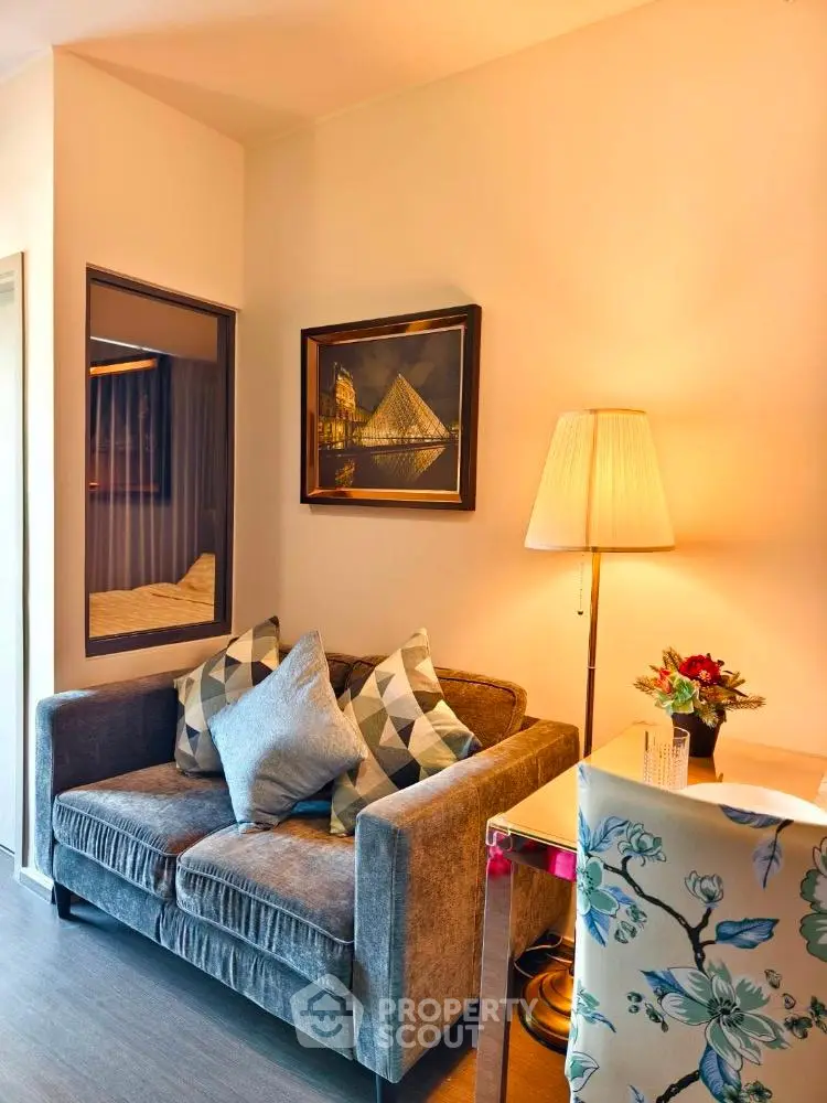 Cozy living room with plush sofa, elegant lamp, and stylish decor in modern apartment.