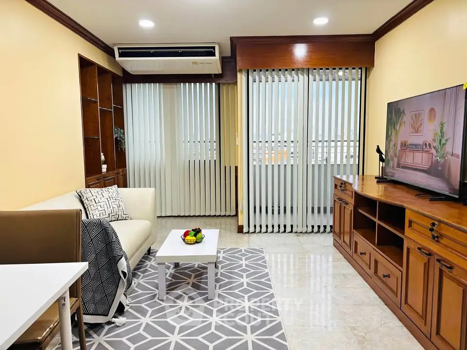 Spacious living room with modern decor and large window view.