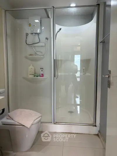 Modern bathroom with glass shower enclosure and sleek fixtures