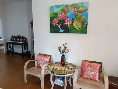 Charming living room corner with floral decor and wooden furniture