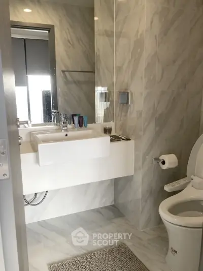 Modern bathroom with sleek marble tiles and contemporary fixtures