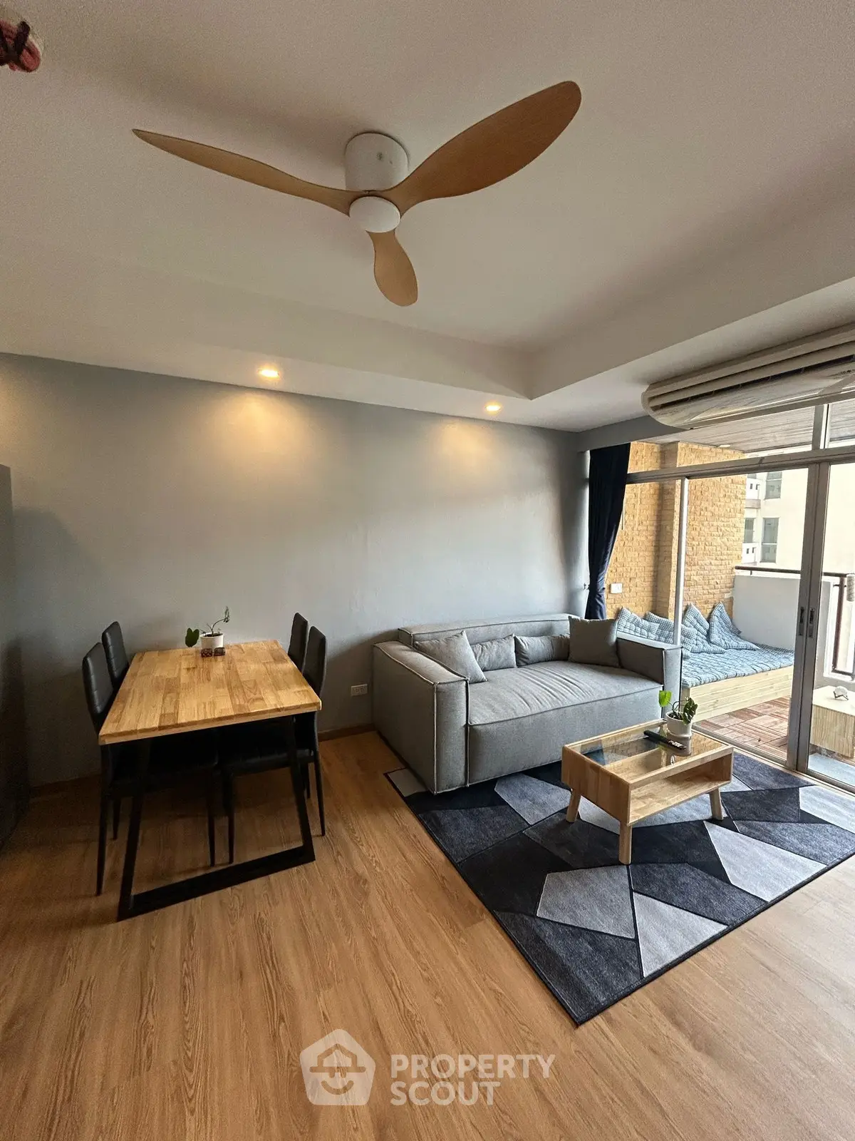 Modern living room with stylish furniture and large balcony access