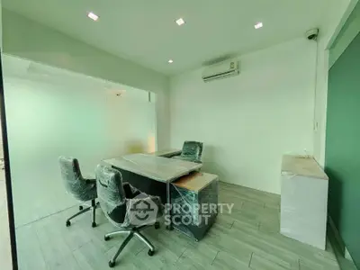 Modern office space with sleek furniture and air conditioning, perfect for productivity.