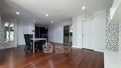 Spacious dining area with elegant wallpaper and wooden flooring