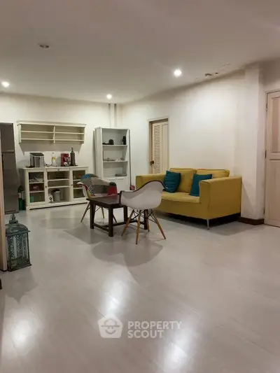 Spacious living room with modern furniture and open layout, perfect for relaxation and entertaining.